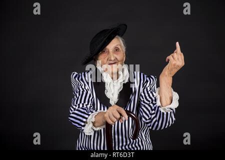 Stilvolle alte Frau in schwarzen Hut mit Sonnenbrille Stockfoto