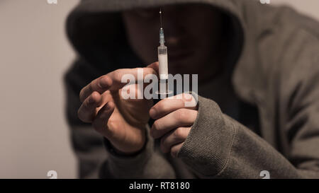 Selektiver Fokus der Junkie Mann, Spritze mit der Dosis von Heroin Stockfoto