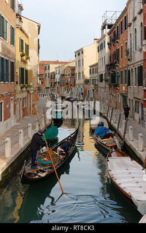 Venedig, Italien - Januar 12, 2019: ein gondoliere bringt einige Touristen entlang einer ruhigen Kanal im Stadtteil Dorsoduro Stockfoto