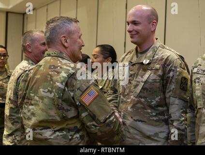 California State militärische Reserve Generalmajor Lawrence Haskins, Kommandant der Kalifornien Army National Guard, Links, schüttelt Hände mit US-Armee Sgt. Benjamin Slade, der 223Rd Military Intelligence Battalion, 115 Region Support Group, nach Vorlage Slade mit einer Kalifornien Commendation Medal, Feb 9, 2019 in Anaheim, Kalifornien, für seine Teilnahme während der jährlichen Beste des Staates Krieger Wettbewerb, der im Januar abgehalten wurde. Slade gewann den Wettbewerb rifle marksmanship Ereignis. Stockfoto