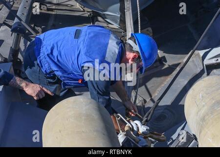 ARABIAN GULF (Feb. 9, 2019) Elektriker Mate 2. Klasse Aaron Averre setzt den Bow-Haken auf den starren - Rumpf Schlauchboot an Bord der Cyclone-Klasse Coastal Patrol Schiff USS Thunderbolt (PC 12). Thunderbolt ist, nach vorn auf die US-Flotte 5 Bereich der Maßnahmen zur Unterstützung der Marine im Einsatz für die Stabilität und Sicherheit in der Region zu gewährleisten und verbindet das Mittelmeer und den Pazifischen Raum durch den westlichen Indischen Ozean und drei strategischen Punkten ersticken. Stockfoto