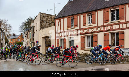 Dampierre-en-Yvelines, Frankreich - 4. März 2018: Das Peloton passiert vor der traditionellen Gebäude in einer kleinen Straße in einem französischen Dorf während Pari Stockfoto