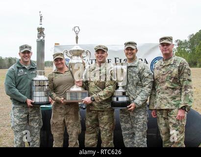 Florida National Guard Soldaten von der 260th Military Intelligence Battalion aus Miami, Florida, posieren mit den Taliaferro Trophy (Top Team Gewehr), Thor-Gray Trophy (Top Team Pistole) und den Brigadier General Clifford R. Trophäe Foster (obere gesamte Team) während der 2019 Adjutant General Gewehr und Pistole übereinstimmen, Feb 9, 2019, Camp Blanding gemeinsame Training Center, Florida. Das TAG Match ist eine Tradition, die 1903 begann. Stockfoto