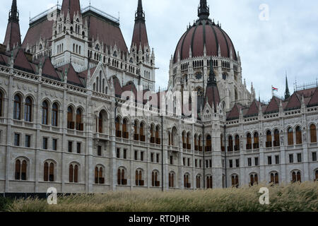 Ungarischen Parlament in Budapest zeigt Details der Architektur und Ornamentik. Kleine rote, weiße und grüne ungarische Flagge sichtbar ist. Stockfoto