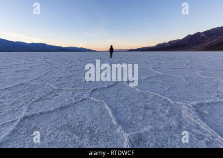 Frau Wandern auf Salz Pan Am Badwater Basin, Death Valley National Park, California, United States. Stockfoto