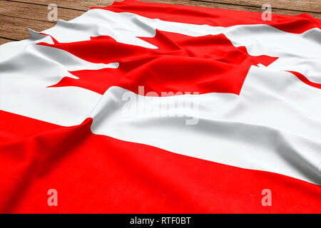 Flagge von Kanada auf einer hölzernen Schreibtisch Hintergrund. Seide kanadischen Flagge Ansicht von oben. Stockfoto