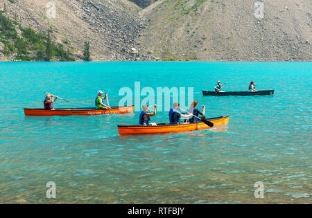 Touristen Kajak auf dem türkis Gletscher Wasser des Lake Moraine in Banff National Park in der Nähe von Lake Louise, Alberta, Kanada. Stockfoto