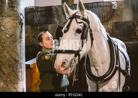 20. Februar 2019. Royal stabil in Dänemark Kopenhagen im Gebiet Christiansborg Slot. Mann junge Frau rider Jockey vorbereiten für ein Zaum, Zaum, oc Stockfoto