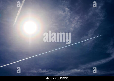 Jet Kondensstreifen Muster erstellen gegen kobaltblauen Himmel & Sonne; Colorado; USA Stockfoto