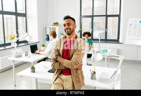 Lächelnd Inder mit smart Watch im Büro Stockfoto