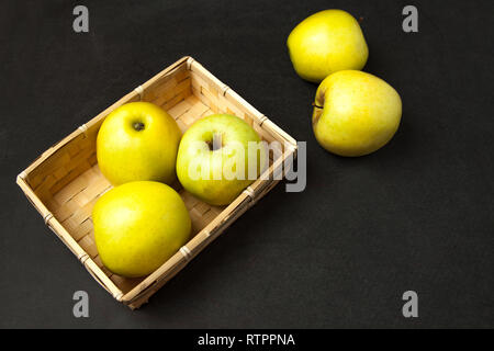 Äpfel. frische reife grüne Äpfel im Korb auf dunklem Hintergrund angeordnet. Ansicht von oben. Stockfoto