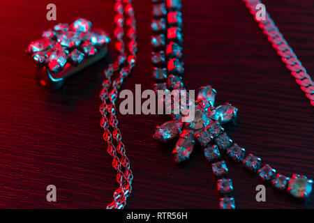 Schmuck auf dunklem Hintergrund im Neonlicht Stockfoto