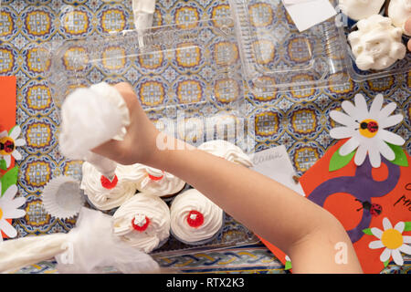 Kinder lernen kleine Kuchen mit Sahne zu kochen. Machen einen Urlaub Karte für Mama. März 8. Stockfoto