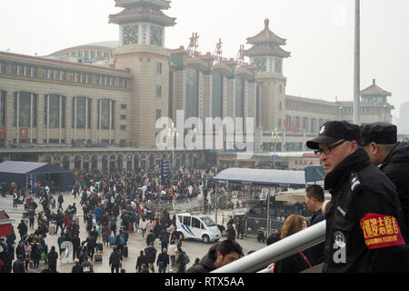 Zwei Männer beobachten Sie die Masse in der Beijing Railway Station. China verbietet 23 m vom Kauf von Fahrkarten als Teil des 'sozialen credit"-System 03-Mar-2019 Stockfoto