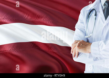 Lettische Arzt stehend mit Stethoskop auf Lettland Flagge Hintergrund. Die nationalen Gesundheitswesen Konzept, medizinische Thema. Stockfoto