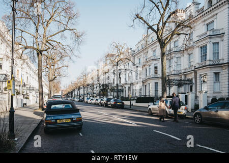 London, UK, 23. Februar 2019: Menschen zu Fuß auf einer Straße in Holland Park, die Royal Borough von Kensington und Chelsea, an einem sonnigen Frühlingstag. Hollan Stockfoto