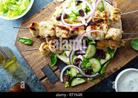 Huhn Kebabs auf ein Fladenbrot mit Gemüse und Oliven, griechischen Mittagessen inspiriert Overhead shot Stockfoto