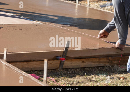 Bauarbeiter aufschnappen Linie in Wet Deck Zement Stockfoto