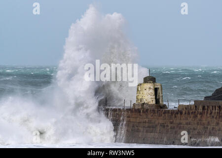 Sturm Freya das Zerschlagen der Cornish Coast mit riesigen Wellen über die historischen Monkey Hütte auf dem Pier in Portreath in Cornwall brechen Stockfoto