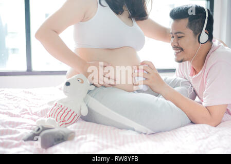 Asiatische schwangere Frau mit Mann. Mutter Tag und Internationalen Tag der Frau. Mama und Kind. Stockfoto