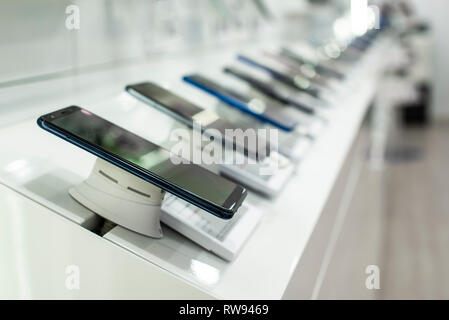 Smartphones auf dem Regal im Store. Konzept für Kommunikation und Technologie. Kaufen Handy in Technik Shop. Stockfoto