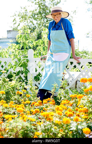 Freudige ältere Frau im Garten Stockfoto