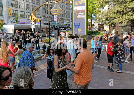 Clevelanders Tanz zu Live-Musik auf US-Bank Plaza an einem Sommerabend in Playhouse Square in der Innenstadt von Cleveland, Ohio, USA Stockfoto