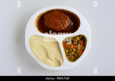 Zubereitete Mahlzeit mit Fleisch, Frikadellen, Kartoffelbrei, Erbsen und Karotten in Kunststoffplatten, Deutschland Stockfoto