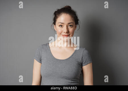 Inhalt junge Frau mit brünetten Haaren chaotisch Brötchen Stockfoto