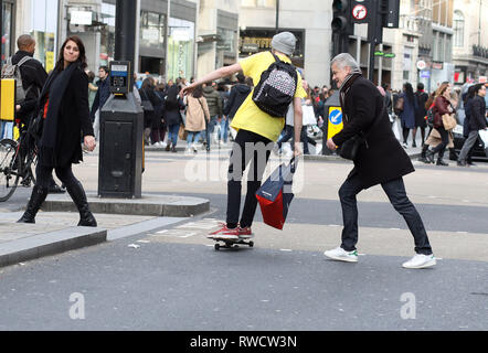 Bild zeigt: Skateboarder und Elektroroller, die Probleme verursacht, auf dem Bürgersteig und auf der falschen Seite der Straße in der Oxford Street. Diese Fußgängerzone w Stockfoto