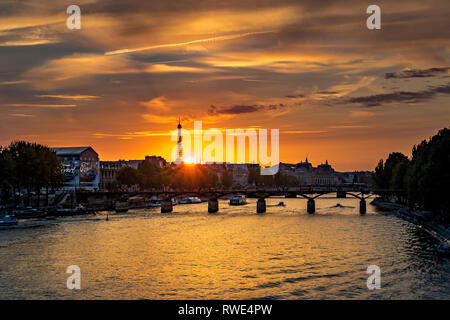 Paris und die seine, die bei Sonnenuntergang unter der Pont des Art fließt, mit dem Eiffelturm in der Ferne, Paris, Frankreich Stockfoto