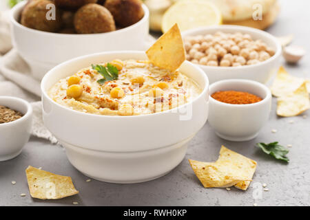 Traditionelle hausgemachte und Falafel und Hummus Kichererbsen serviert mit Pita, Chips und Gewürzen. Stockfoto