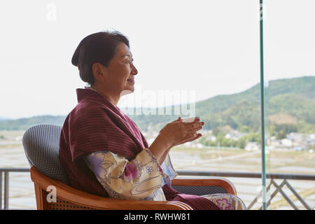 Japanische ältere Frau mit Yukata an einem traditionellen Hotel Stockfoto