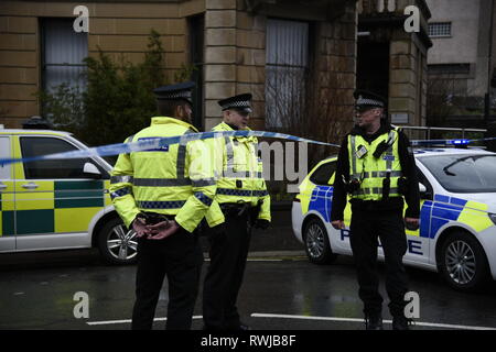 Glasgow, Glasgow, UK. 6 Mär, 2019. Polizisten gesehen, diskutieren die Situation während der Untersuchung. Die Polizei hat ein verdächtiges Paket an der Universität Glasgow in Schottland gefunden. Polizei und Campus Mitarbeiter haben den Bereich abgeschaltet. Credit: Stewart Kirby/SOPA Images/ZUMA Draht/Alamy leben Nachrichten Stockfoto