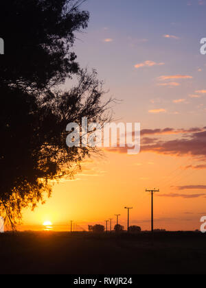 Schönen Sonnenuntergang in den Bereichen Argentinien mit elektrischen Polen bis zum Horizont gehen Stockfoto