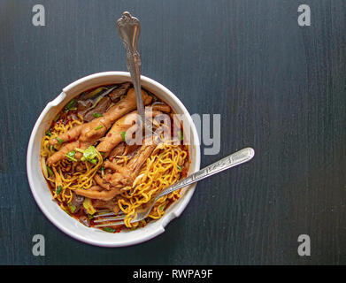 Geschmorte Hühnersuppe mit bitteren Kürbis Nudel. Huhn Kürbis Nudeln mit Huhn Bein, Thai Food. Chicken Claw mit würziger Suppe. Stockfoto
