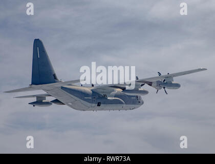 Ein U.S. Marine Corps KC-130J Super Hercules mit Marine Antenne Refueler Transport Squadron (VMGR) 152 fliegt vor der Küste von Japan, 28.02.2019. Us-Marines mit VMGR-152 bieten eine Vielzahl von Funktionen in der gesamten INDOPACOM Bereich Luftbetankung, Personal- und Cargo Transport und Lieferungen zu gehören. (U.S. Marine Corps Foto von Lance Cpl. Tyler Harmon) Stockfoto