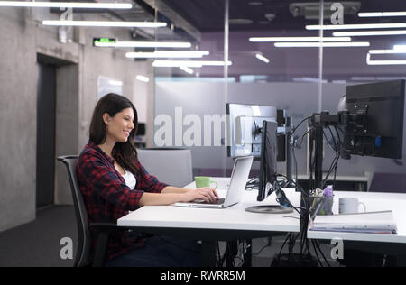 Junge Frau mit Laptop Computer Software Entwickler beim Schreiben von Programmcode auf modernen, kreativen Start Büro Stockfoto