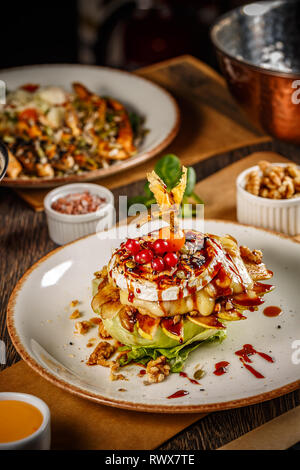 Gegrilltem Camembert mit gebackene Birnen und Walnüssen, in einem Restaurant serviert. Stockfoto