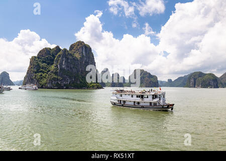 Kreuzfahrt Boote segeln unter die Karsterscheinungen in der Halong Bay, Vietnam, im Golf von Tonkin. Halong Bay ist ein UNESCO-Weltkulturerbe und die Stockfoto