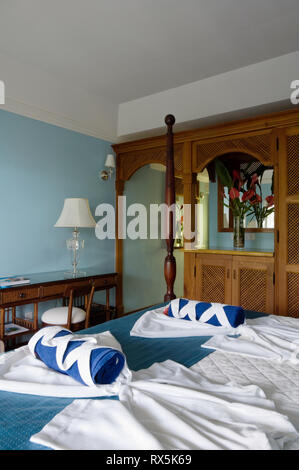 Handtücher und Bademäntel auf Bett im Hotelzimmer Stockfoto