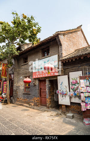 Juli 2016 - Luoyang, China - Die kleine Straße, die durch die antike Stadt Luoyang läuft, voller Zeichen von Läden, die Kunst und die Art des Materials. Stockfoto