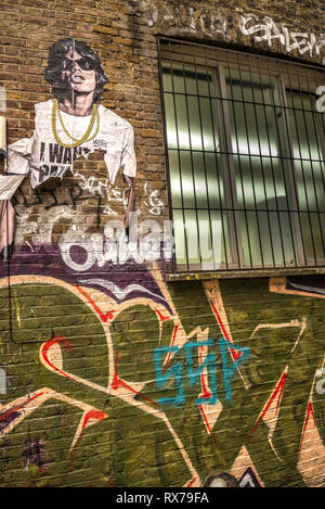 Mick Jagger Schablone Kunst auf Graffiti verkleideten Wände der spitlefied, East London. Stockfoto