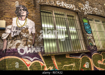 Mick Jagger Schablone Kunst auf Graffiti verkleideten Wände der spitlefied, East London. Stockfoto