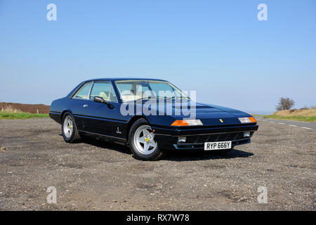 Ferrari 400 durch einen Feldweg in der Derbyshire Peak District an einem sonnigen Tag geparkt Stockfoto