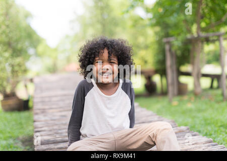 Porträt einer niedlichen Afrikanische amerikanische kleiner Junge am Naturpark lächelnd. Stockfoto