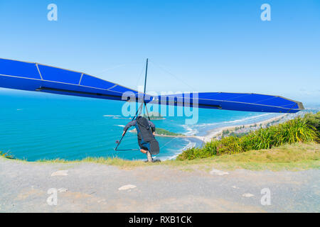 Take-off hanglider Pilot läuft am Hang mit malerischen Stränden von Mount Maunganui unten. Stockfoto