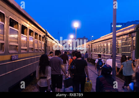 Passagiere auf einer Plattform mit Züge entweder Seite an Hanoi Bahnhof (Ga Hà Nội) Am frühen Morgen, Hanoi, Vietnam Stockfoto