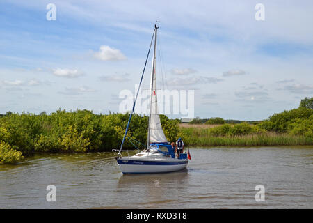 Kleines Segelboot bis zu reisen die Suffolk Broads, in der Nähe von Oulton Broad, Suffolk, Großbritannien Stockfoto