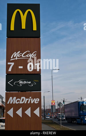 McDrive und McCafe Zeichen mit Wegbeschreibung und Öffnungszeiten Stockfoto